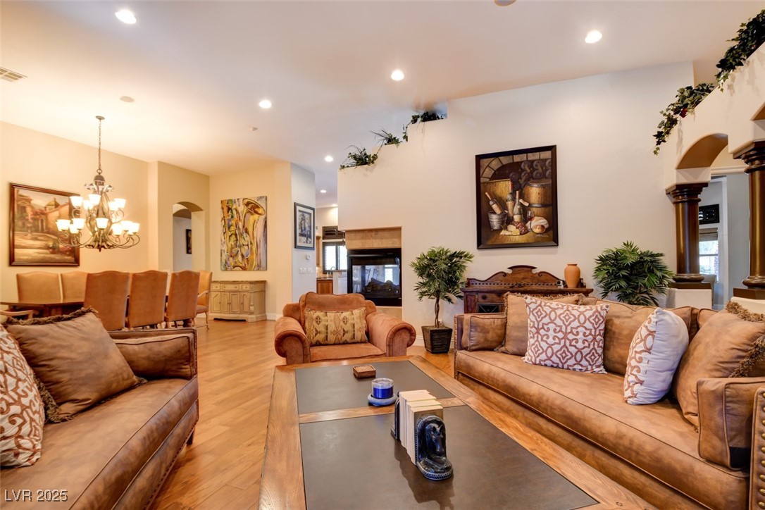 8465 West Picket Ridge Court Las Vegas, NV 89143 - Photo 8 of 51 Light-Filled Living Room with Impressive Height and Fireplace Feature