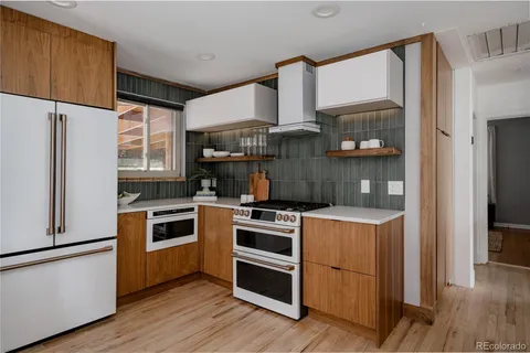 a kitchen with a stove a refrigerator and a sink