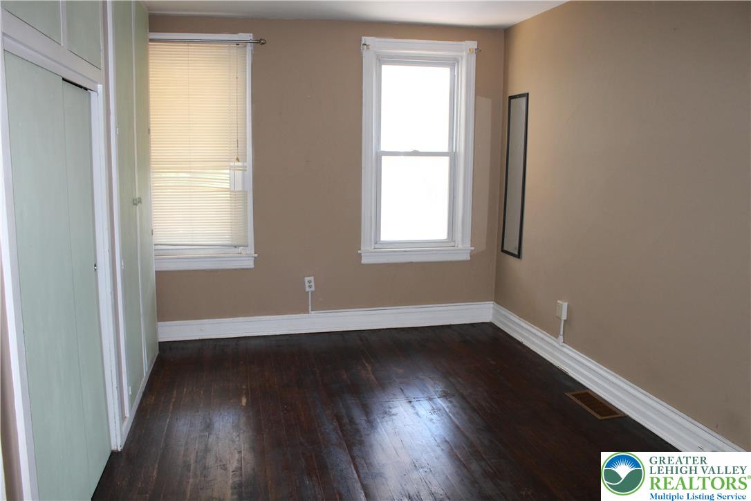 610 West Garrison Street, Unit 1 Bethlehem, PA 18018 - Photo 11 of 15 an empty room with wooden floor and windows