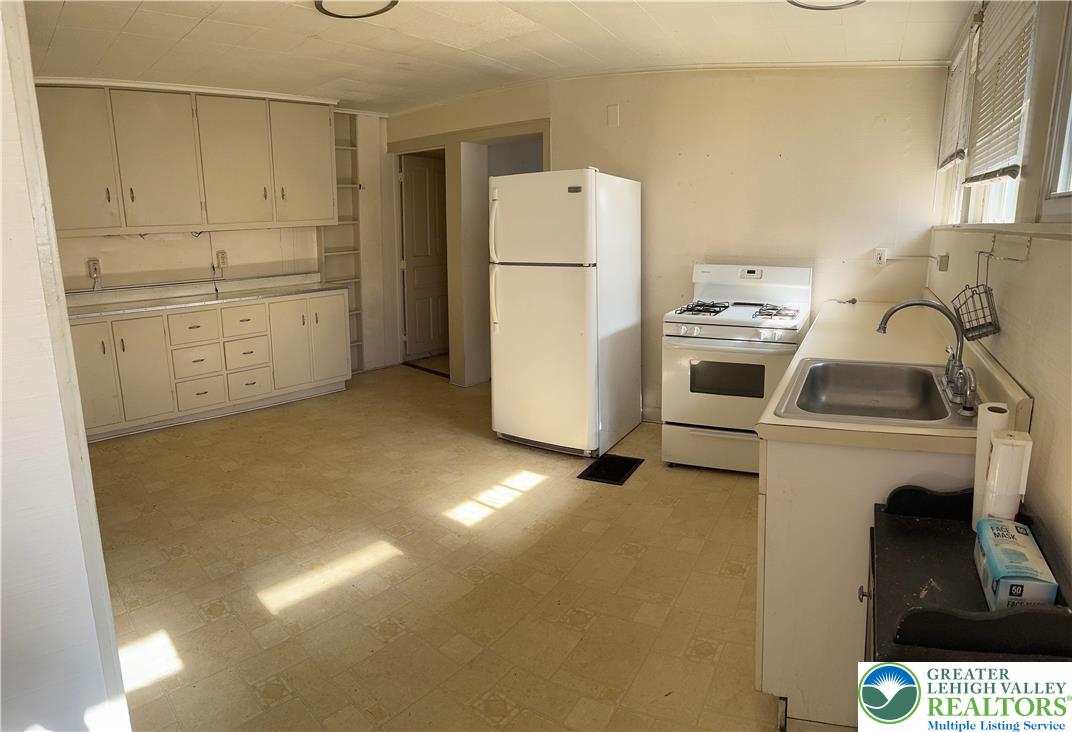 610 West Garrison Street, Unit 1 Bethlehem, PA 18018 - Photo 4 of 15 a kitchen with a refrigerator sink stove and cabinets