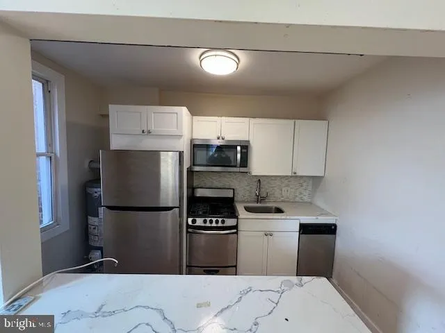 a kitchen with a refrigerator and a stove