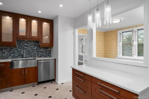 a kitchen with stainless steel appliances granite countertop a sink a stove and a window