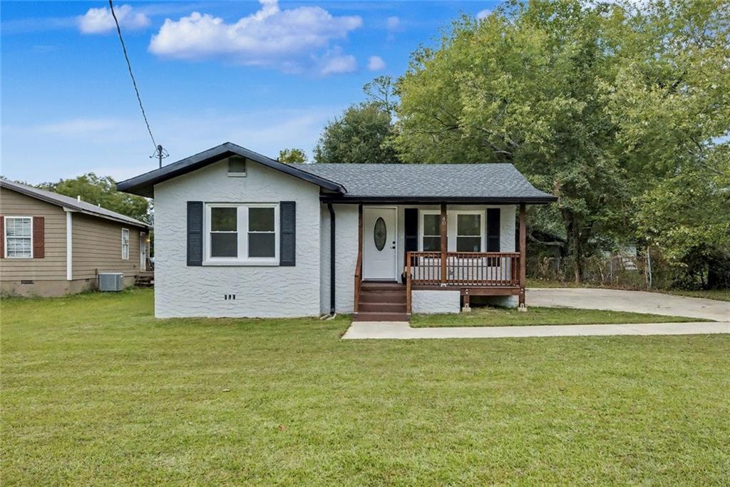 a front view of a house with a yard table and chairs