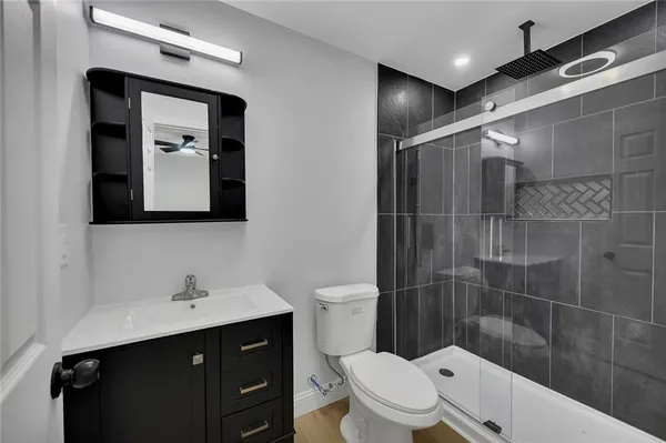 a bathroom with a toilet sink shower and mirror