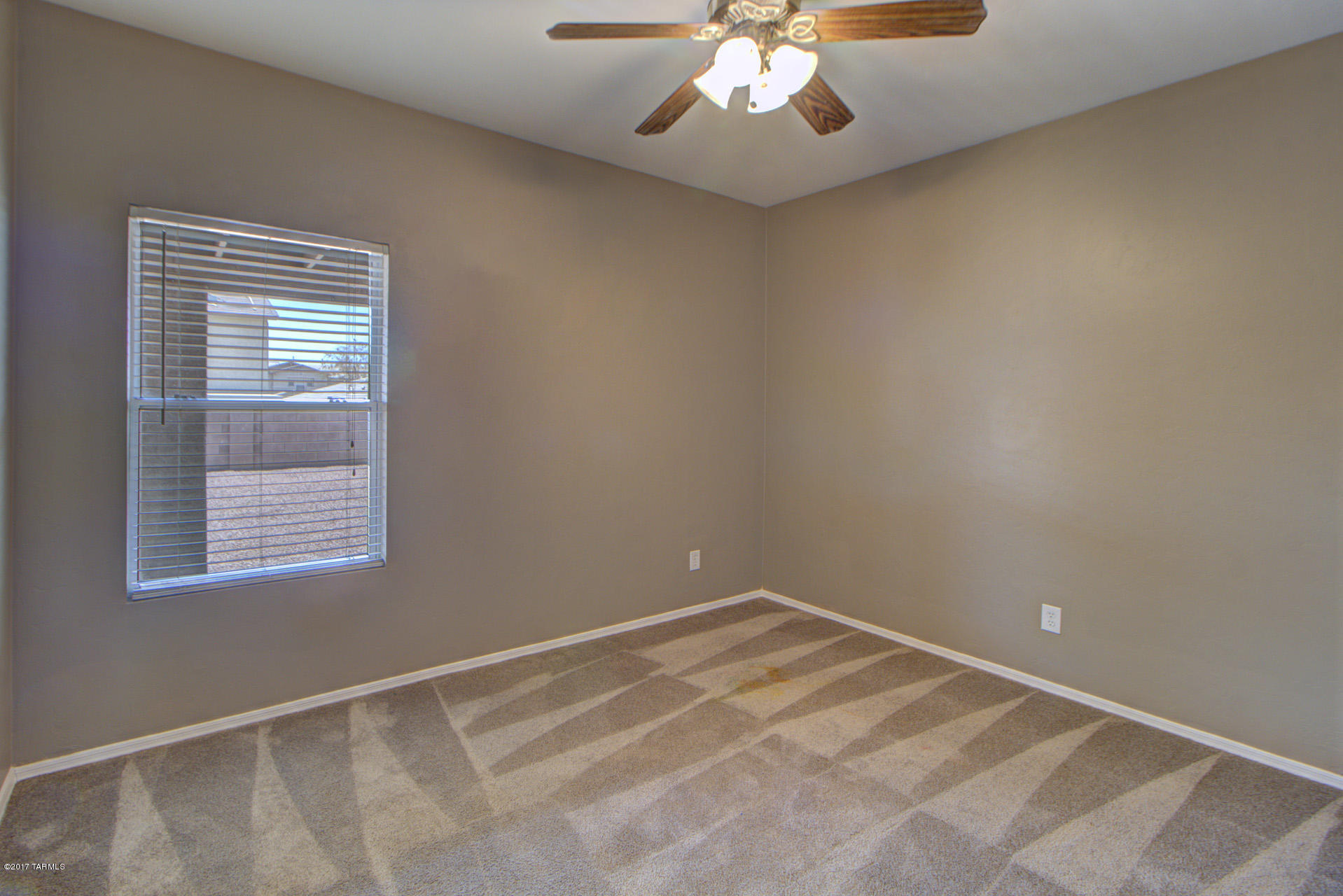 3588 East Mecate Road Tucson, AZ 85739 - Photo 14 of 36 a view of an empty room with a window