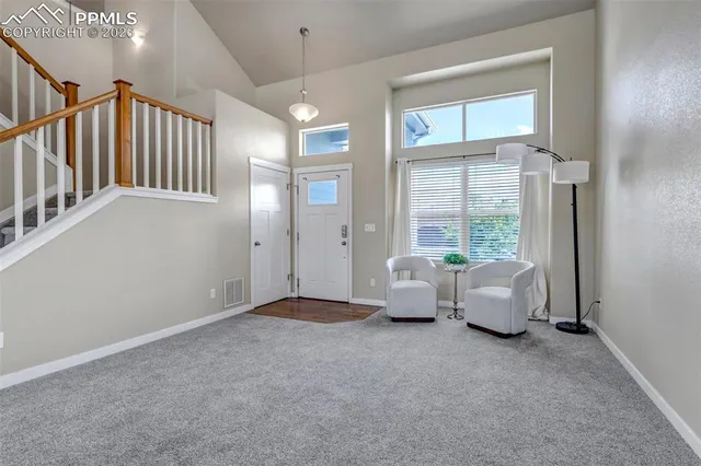 an entryway and livingroom with furniture