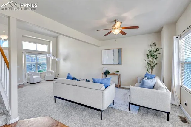 a living room with furniture and a large window