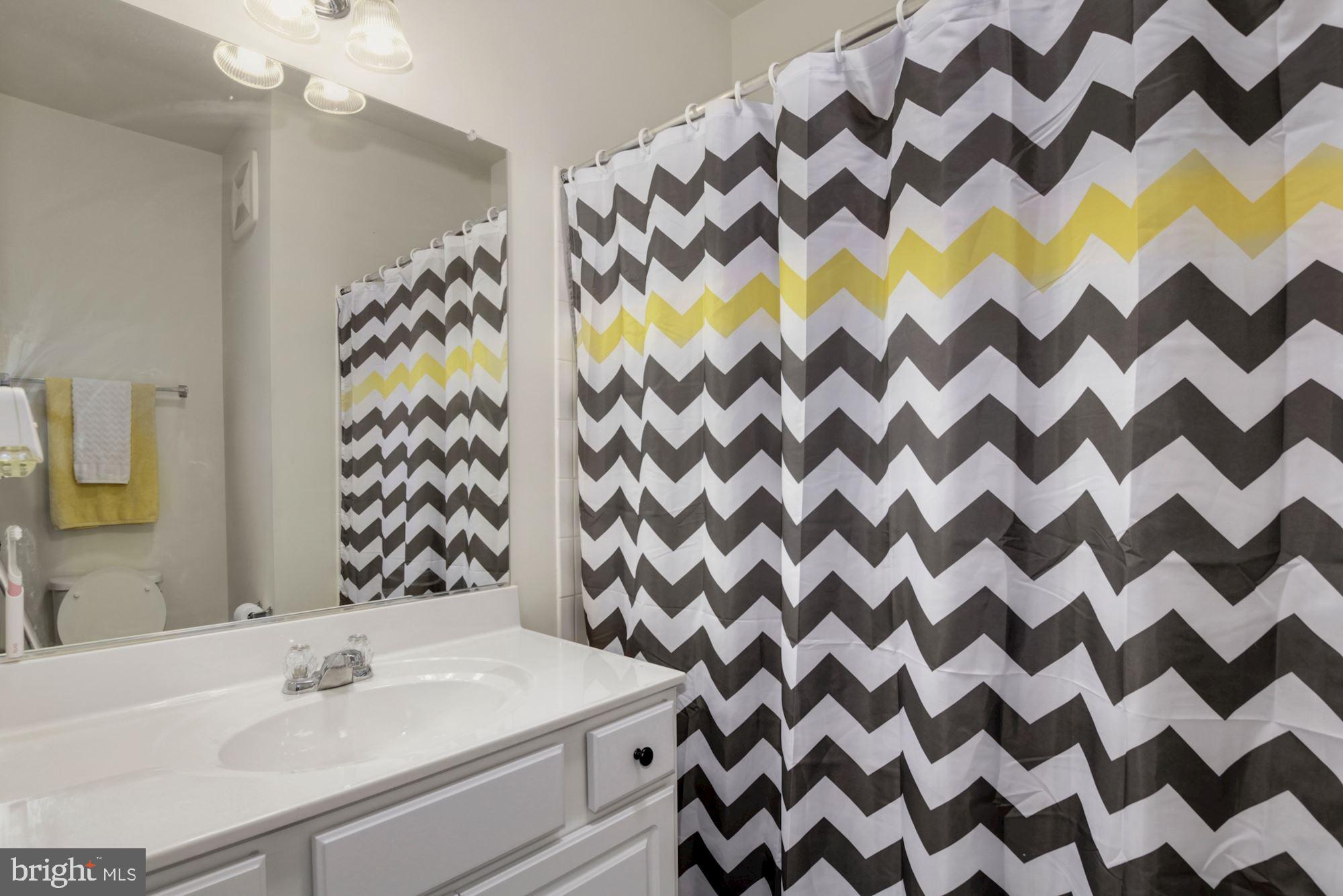 3825 Doc Berlin Drive, Unit 17 Silver Spring, MD 20906 - Photo 26 of 34 a bathroom with a sink and a mirror