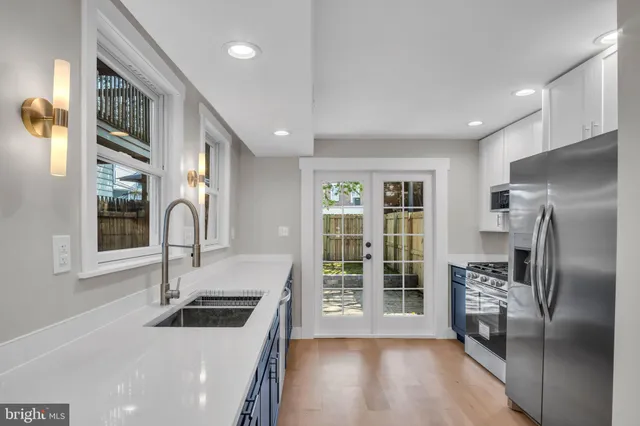 a kitchen with a refrigerator and a sink