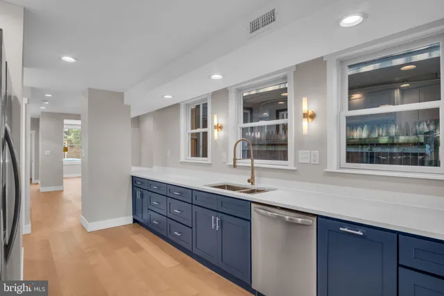 a bathroom with a granite countertop sink mirror and double