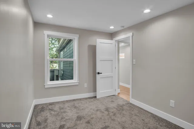 an empty room with windows and closet