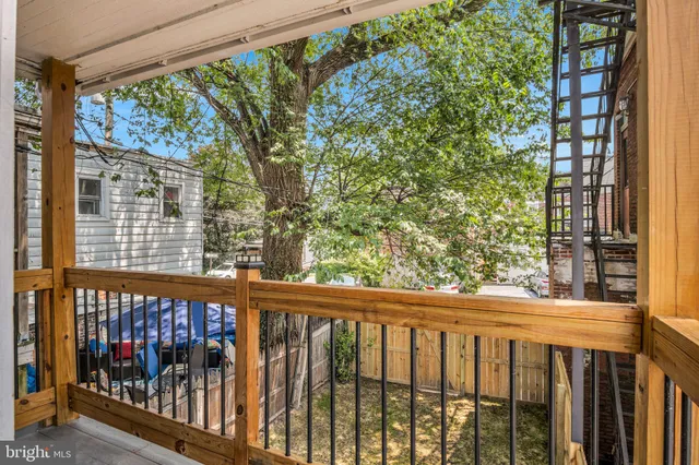 a view of a balcony with a green space