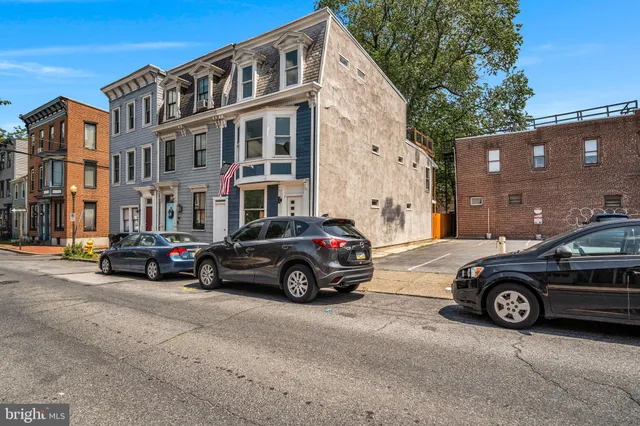 a car parked in front of a car parked in front of a house