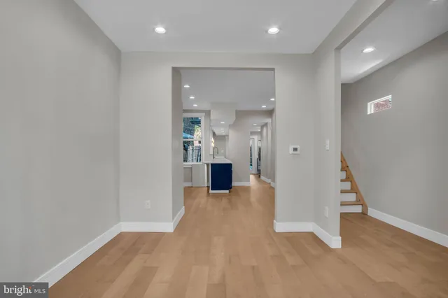 wooden floor in a room with a bathroom