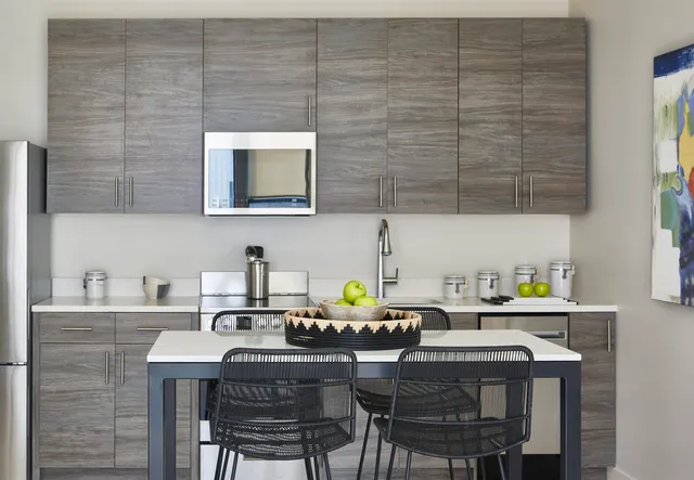 a kitchen with a dining table chairs and a sink