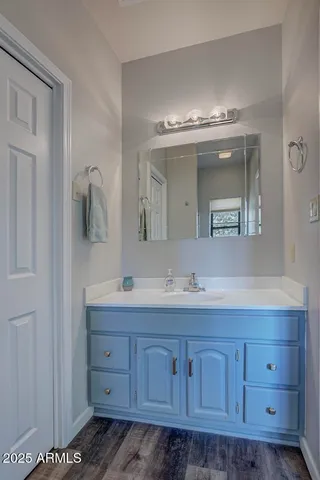 a bathroom with a double vanity sink and a mirror