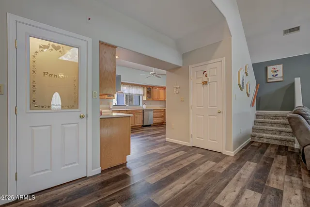 a view of a kitchen from the hallway with wooden floor