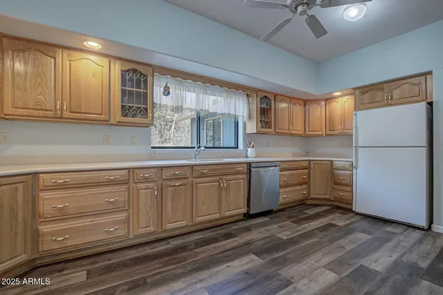 a kitchen with granite countertop white cabinets and white appliances