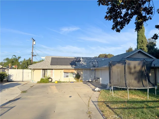 a view of a house with a yard and sitting area