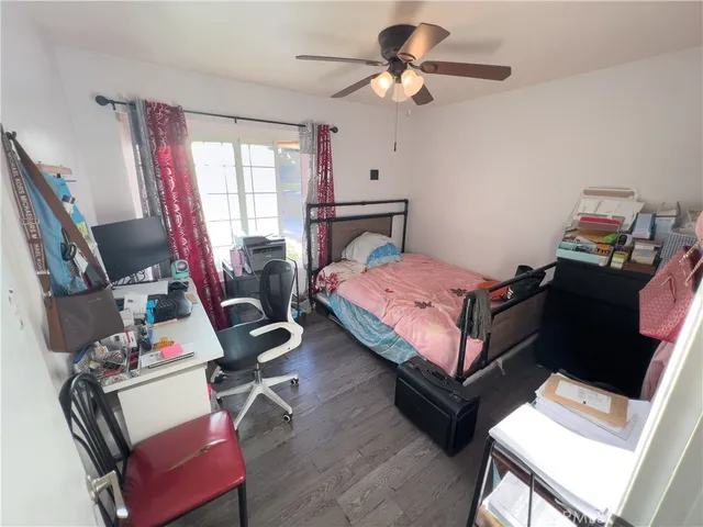 a bedroom with a bed and a desk