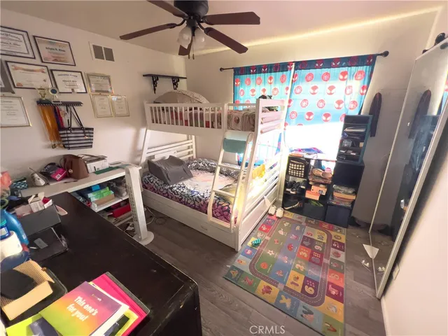 a bedroom with furniture and a flat screen tv