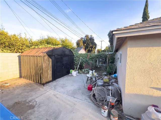 a view of a backyard with tv and outdoor seating
