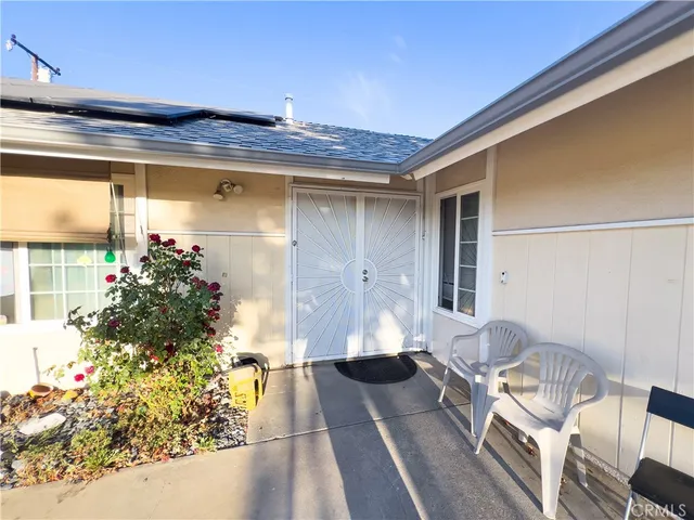 a front view of a house with outdoor seating