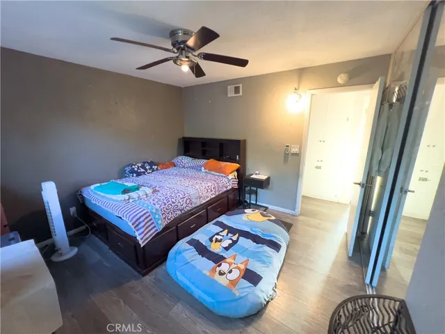 a bedroom with furniture and a wooden floor