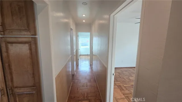 a view of a hallway with wooden floor