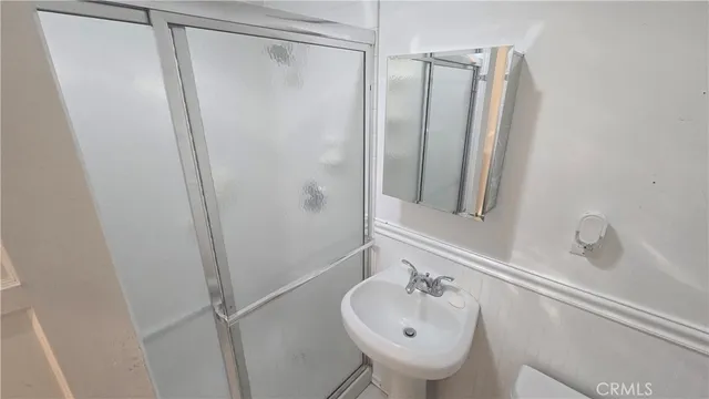 a bathroom with a sink a mirror and a shower