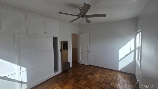 a view of a livingroom with a ceiling fan and window