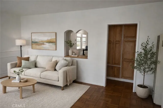 a living room with furniture and a potted plant