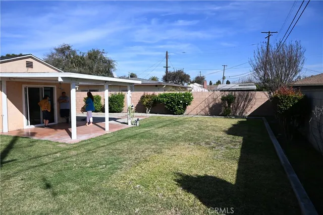 a view of a house with backyard porch and sitting area