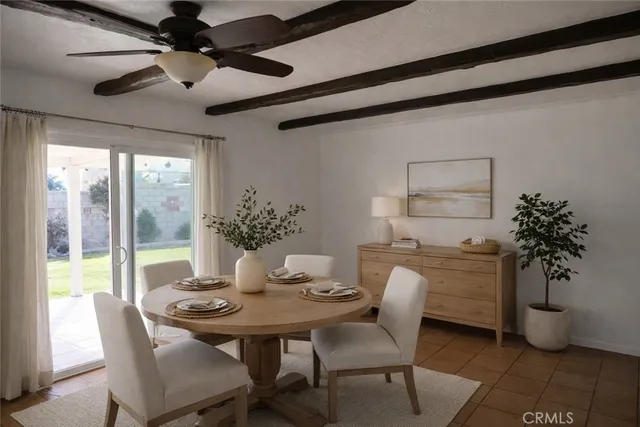 a dining room with furniture potted plants and wooden floor