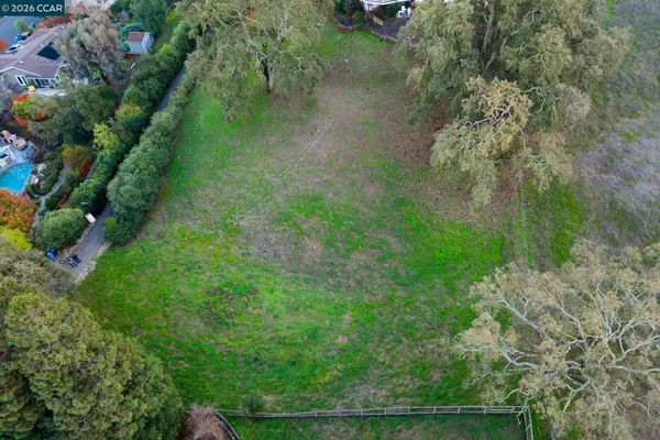 a view of a field of grass and trees