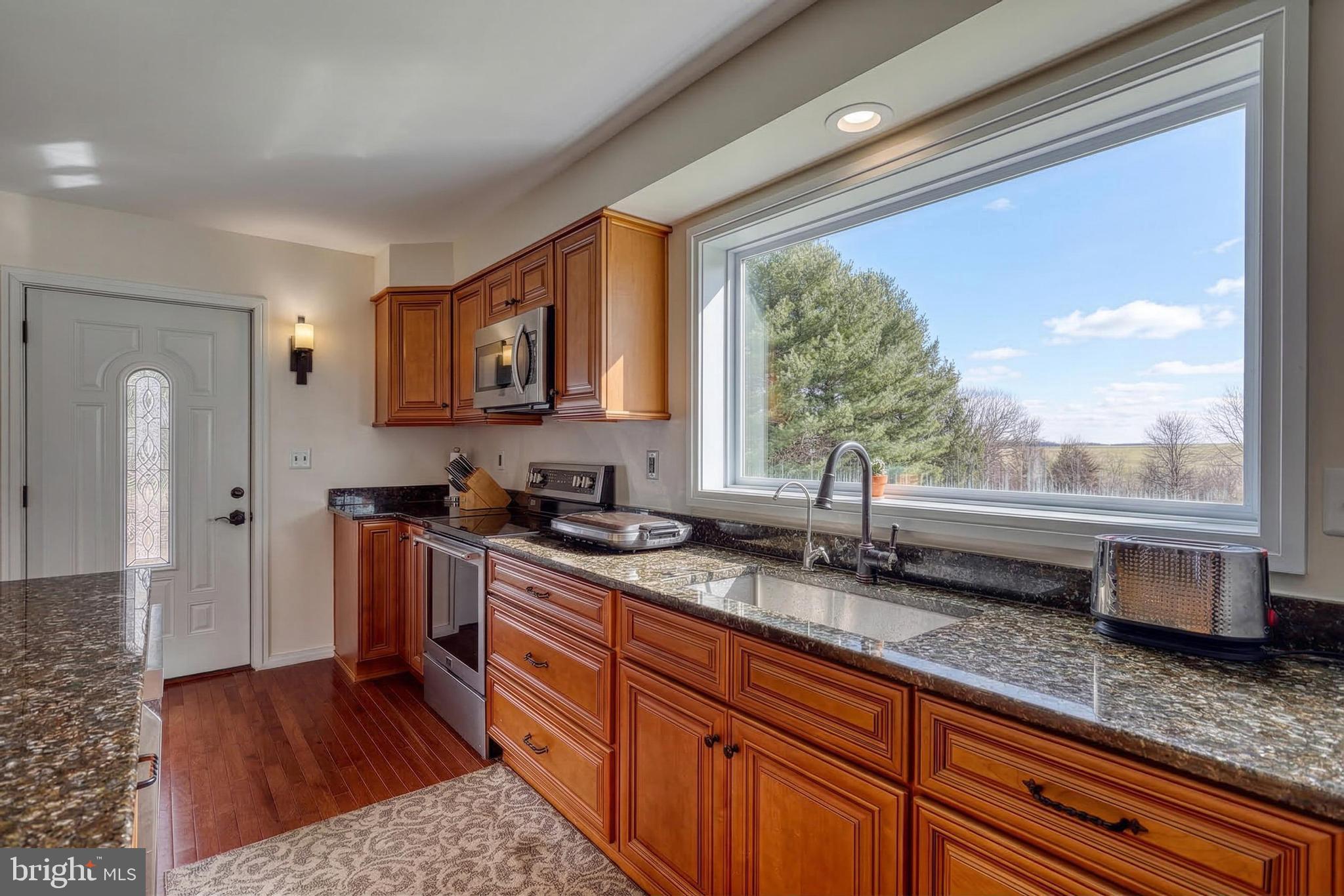 12534 Mt Olivet Road Felton, PA 17322 - Photo 17 of 75 a kitchen with stainless steel appliances granite countertop a sink stove and cabinets