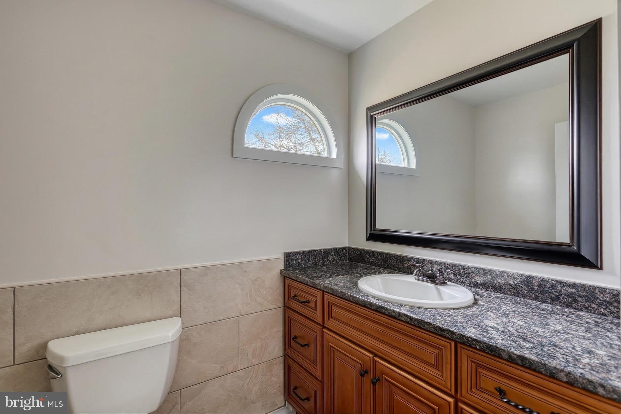 12534 Mt Olivet Road Felton, PA 17322 - Photo 30 of 75 a bathroom with a granite countertop sink and a mirror