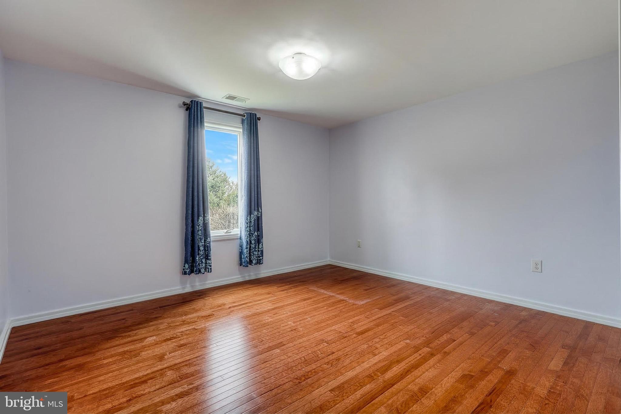 12534 Mt Olivet Road Felton, PA 17322 - Photo 47 of 75 a view of an empty room with wooden floor and a window