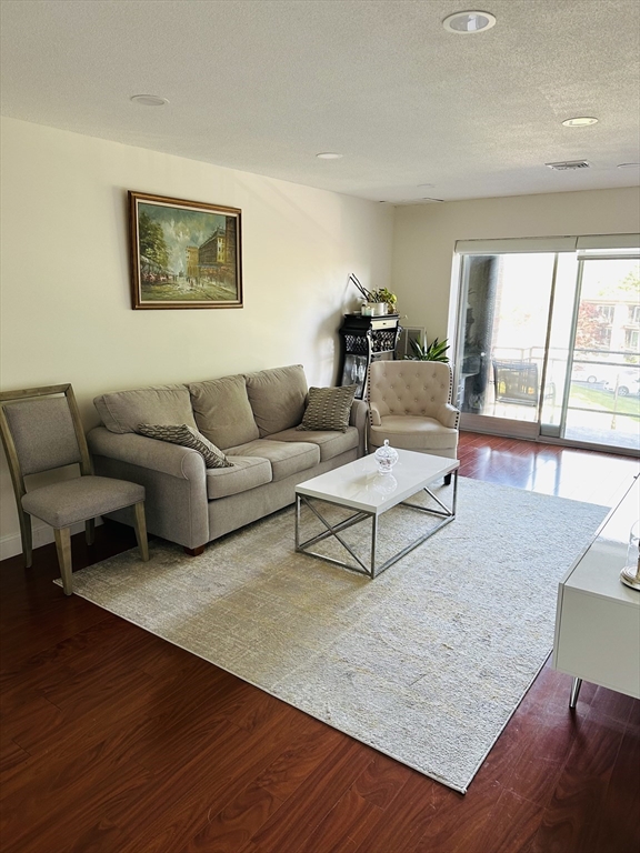 1202 Greendale Avenue, Unit 135 Needham, MA 02492 - Photo 2 of 6 a living room with furniture and a large window