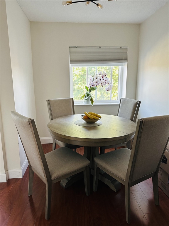 1202 Greendale Avenue, Unit 135 Needham, MA 02492 - Photo 4 of 6 a view of a dining room with a table and chairs