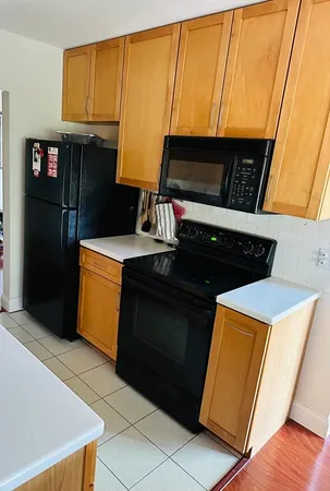 a bedroom with a bed wooden floor and window