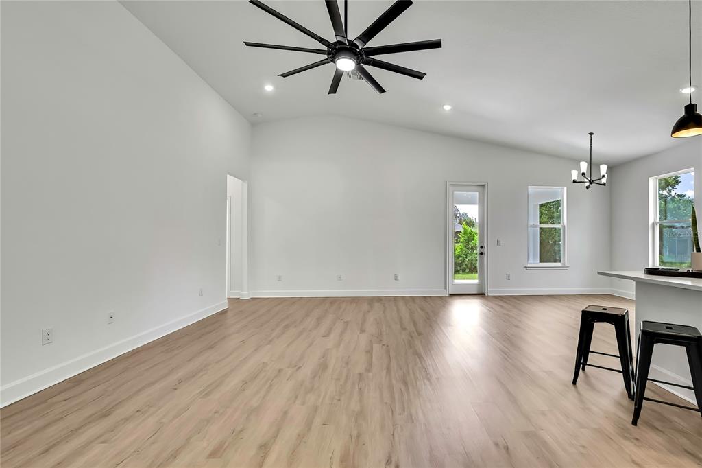 6589 Freeport Drive Spring Hill, FL 34608 - Photo 23 of 63 an empty room with wooden floor and windows