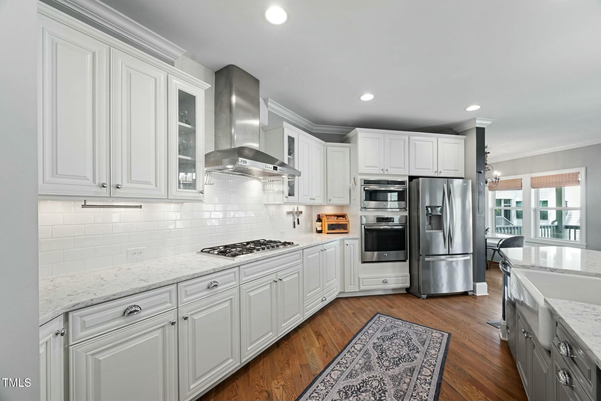 11808 Venture Oak Way Raleigh, NC 27613 - Photo 10 of 42 a kitchen with stainless steel appliances granite countertop a refrigerator sink and cabinets
