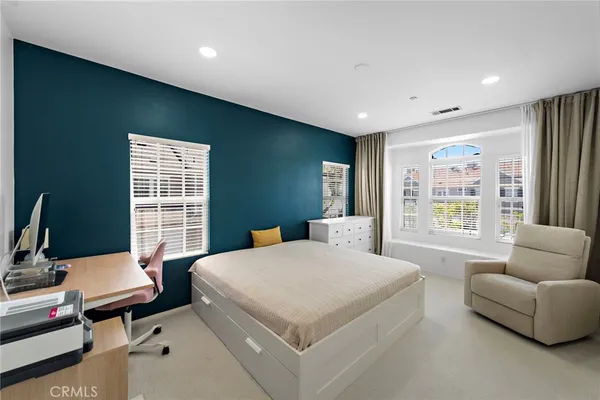 a bedroom with a bed and a couch