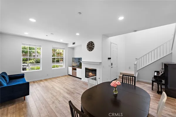 a living room with fireplace furniture and a large window