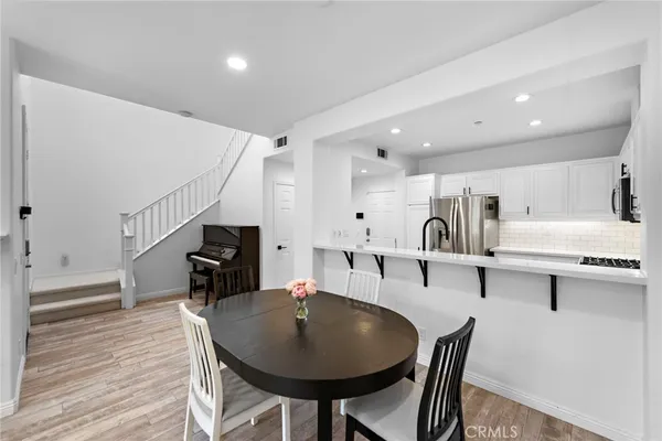 a dining room with furniture and wooden floor