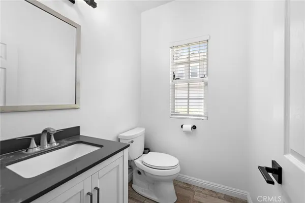 a bathroom with a sink vanity mirror and toilet