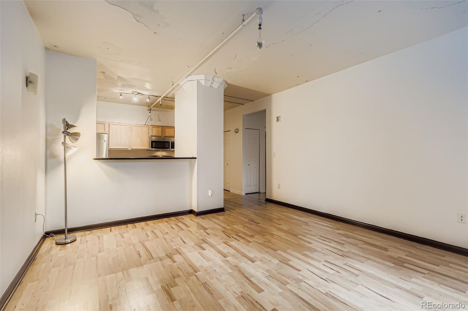444 17th Street, Unit 404 Denver, CO 80202 - Photo 3 of 37 a view of a kitchen with wooden floor and a sink
