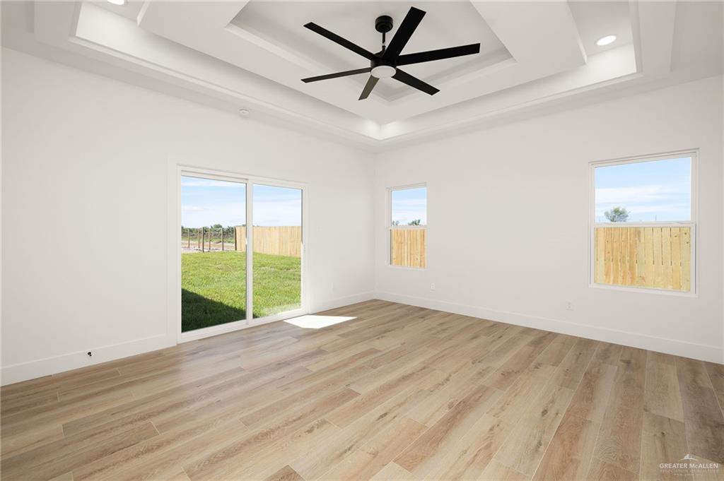 2525 Trinity Avenue McAllen, TX 78504 - Photo 12 of 33 a view of an empty room with a window and wooden floor