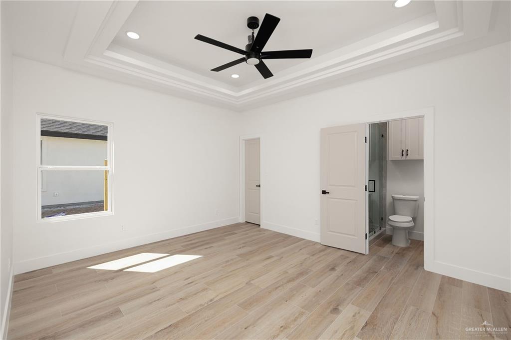 2525 Trinity Avenue McAllen, TX 78504 - Photo 13 of 33 a view of empty room with wooden floor and a ceiling fan